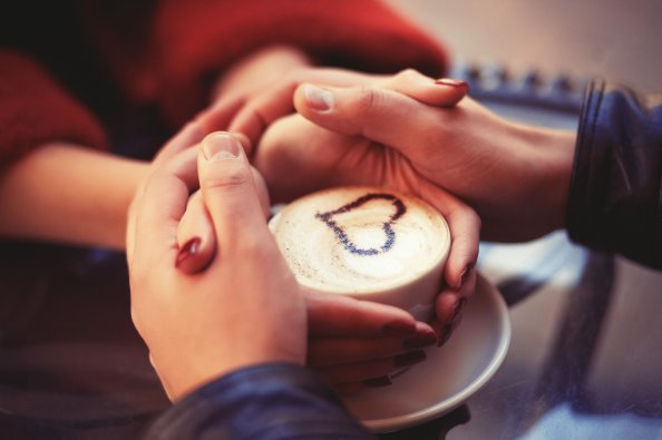 Couple Holding Hands At Coffee