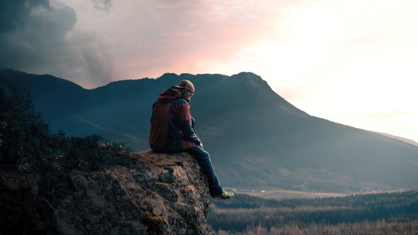 Boy Sitting Alone On High Mountain Rock 5k