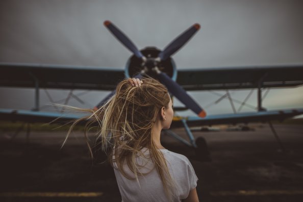 Women Hands In Hair Standing In Front Of Plane 5k