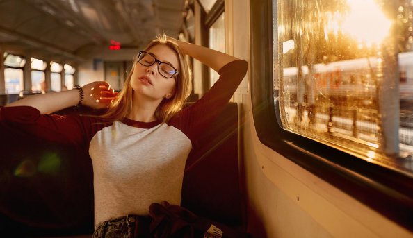 Women With Glasses Closed Eyes Sitting In Train