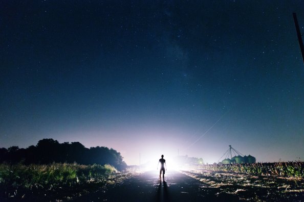 Man Standing In Front Of Light