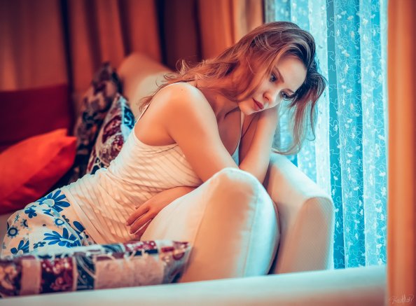 Girl Sitting On Couch Thinking