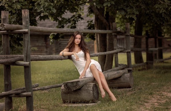 Girl Sitting On Wooden Fence Bench