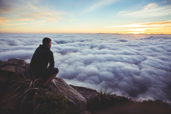 Person Looking At The Clouds From Top