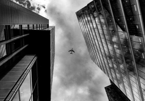 Plane Between Two Buildings Monochrome