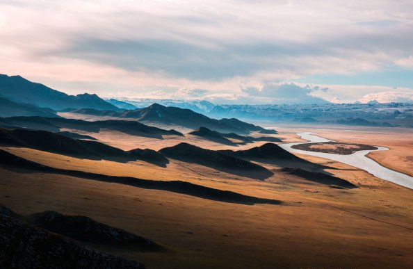 Brown Mountains Near Body Of Small Lake