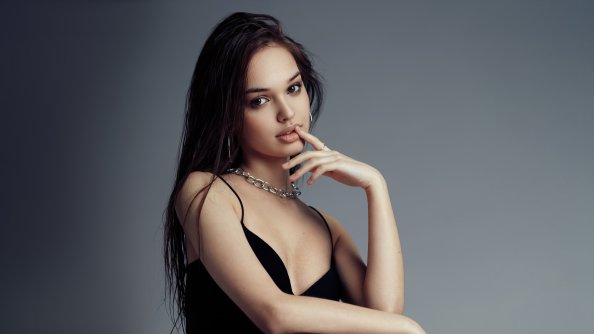 Evelina Sitting On A Chair And Looking At Viewer