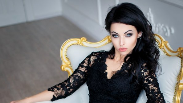 Brunette Girl In Black Dress Sitting