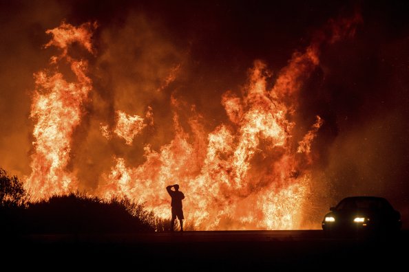 Man Watching Fire In The Jungle
