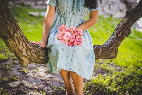 Girl Sitting Flowers In Hand