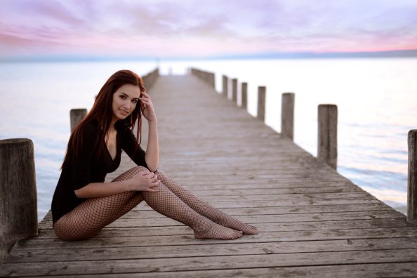 Girl Sitting On Pier