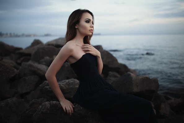Girl Sitting On Rocks