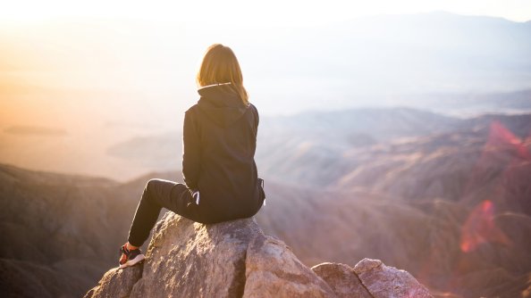 Hiking Girl Sitting On Rock
